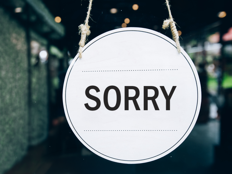 Sorry Sign in shop window reads "sorry"